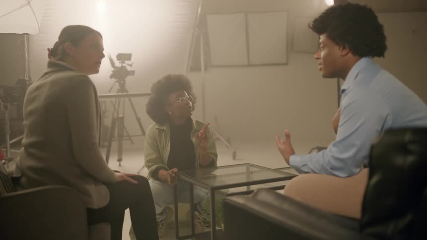 A director gives instructions to actors in the set