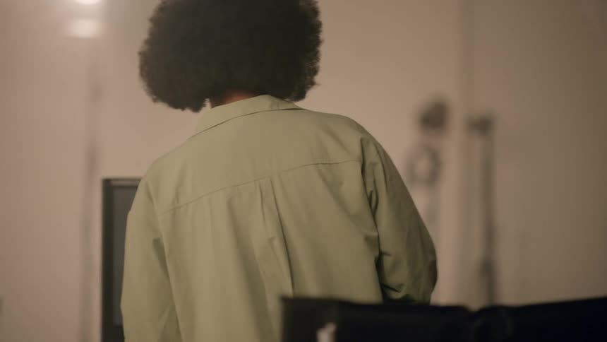 Woman scriptwriter talking to two presenters in a recording studio and then sitting down