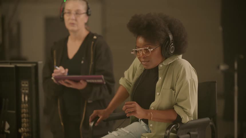 Woman sitting on the directors chair on the set