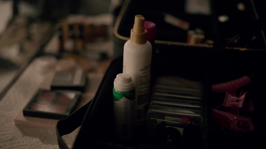Closeup of a black case containing makeup and personal care products