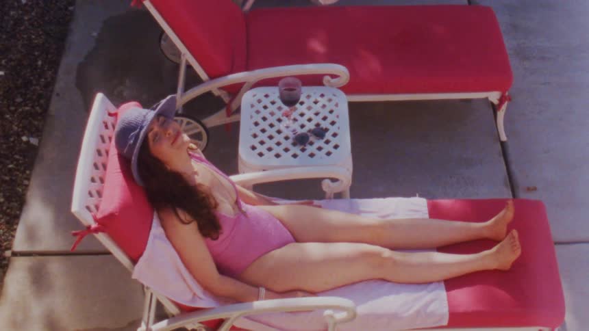 A young woman sunbathes outdoors