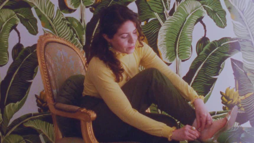 Woman sitting on a chair and removing her high heels