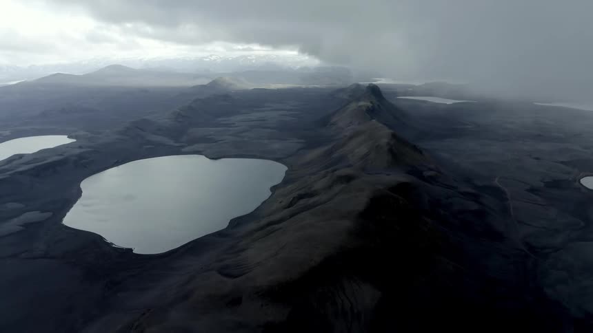 A storm beyond a mountain lake