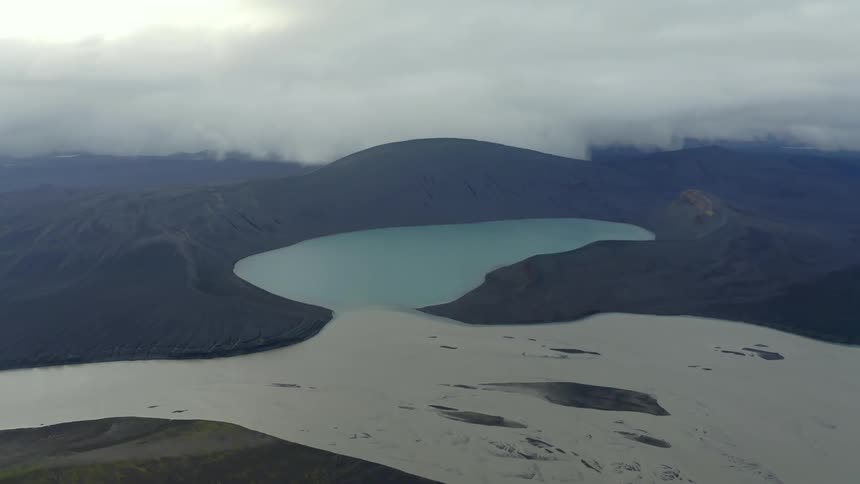 A glacier feeds into a volcanic lake