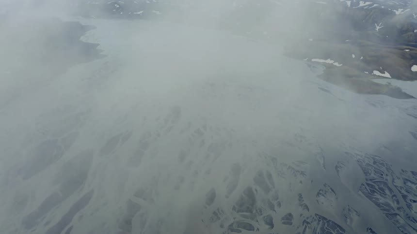 A frozen glacier river near mountains