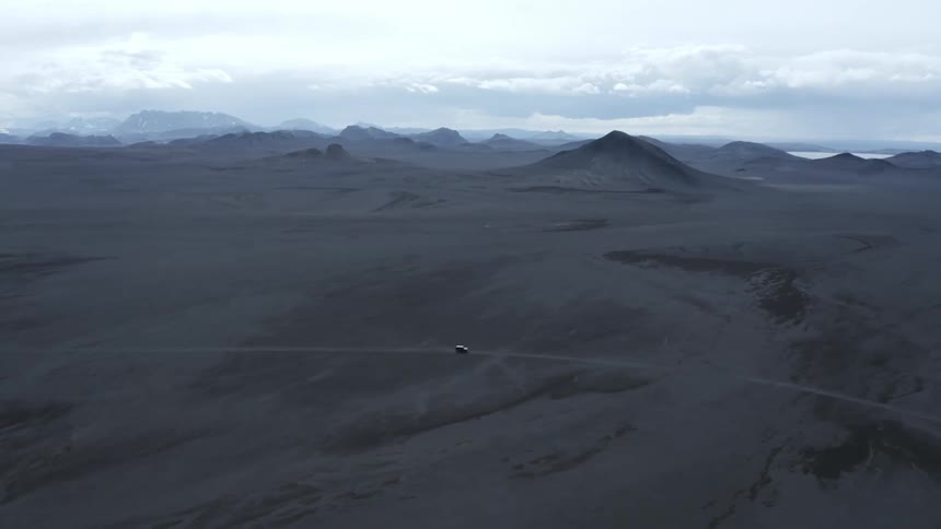 Car is driving through the wilderness near mountaintops