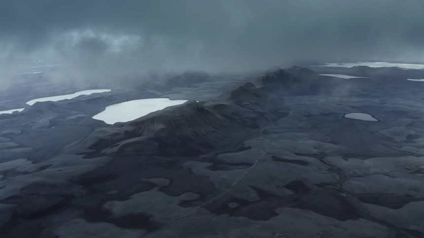 An aerial clip of a misty landscape in a black desert