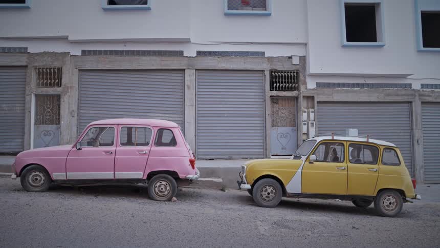 Two vehicles parked outside a building