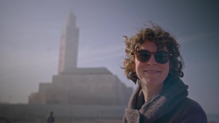 Portrait of a woman outdoors with sunglasses smiling