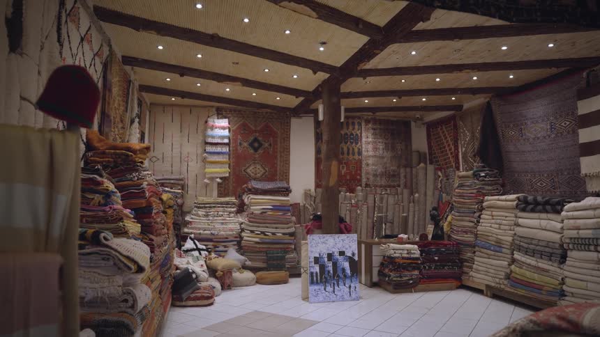 A store filled with various rugs