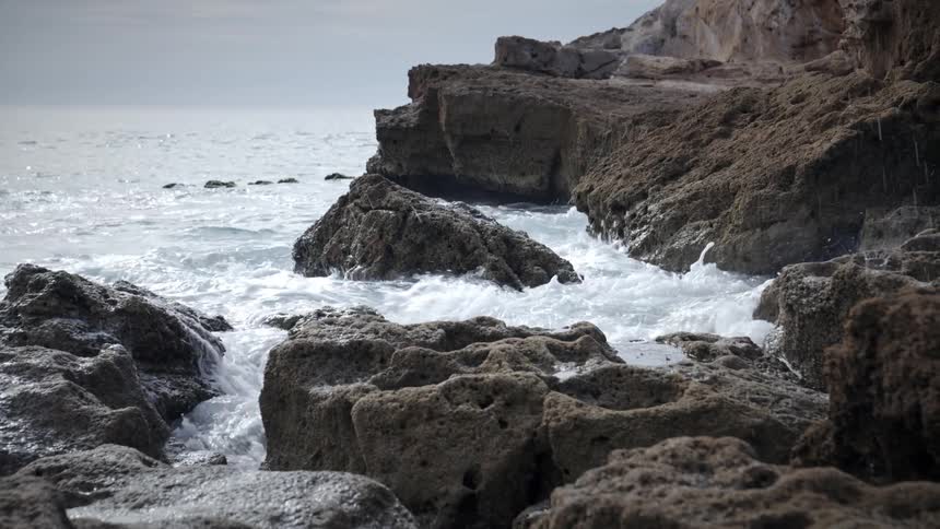 Ocean waters hitting rocks on the coast