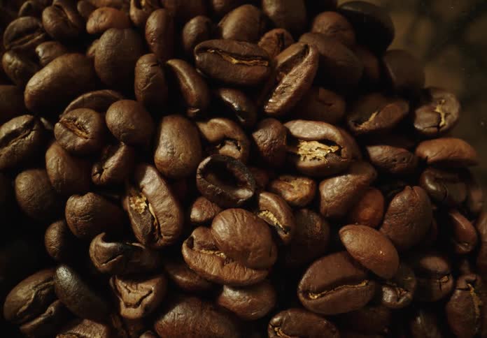 Fresh coffee beans are piled together