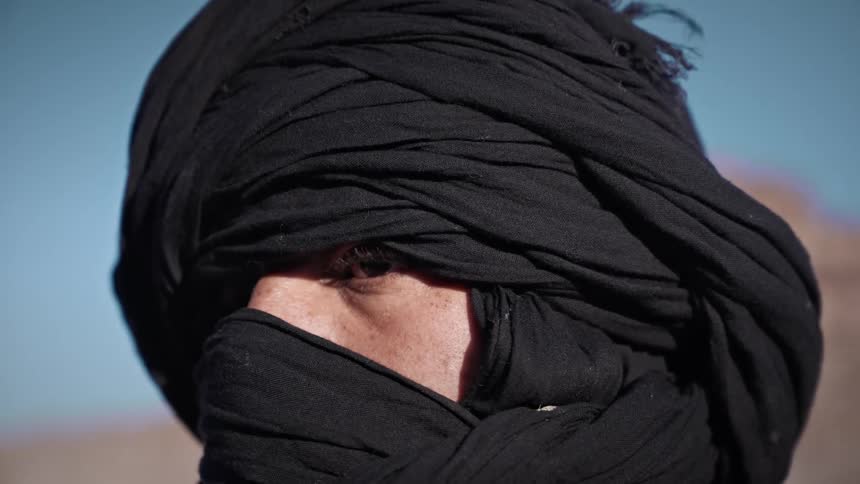 A man wearing a turban outside on a sunny day