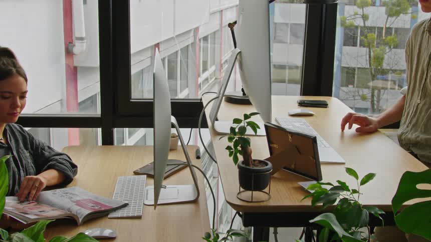 An employee makes his office desk rise up