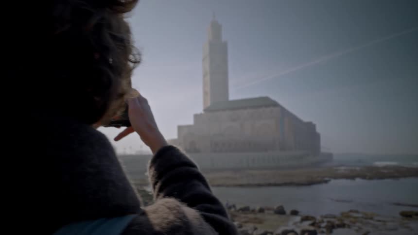 A person films a giant building