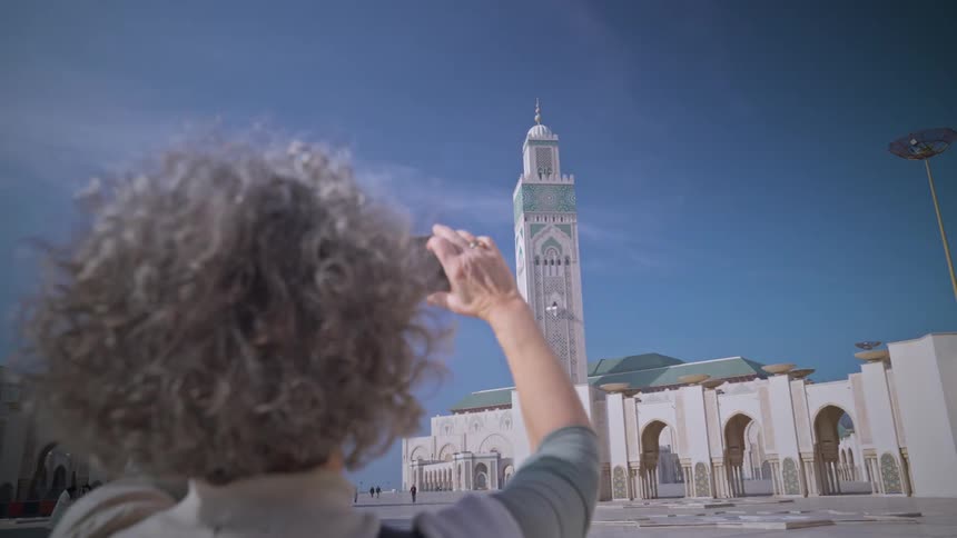A tourist films a mosque