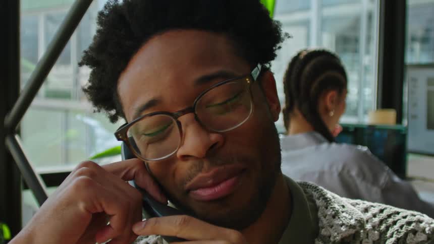 A clip of a man in an office setting receiving a phone call