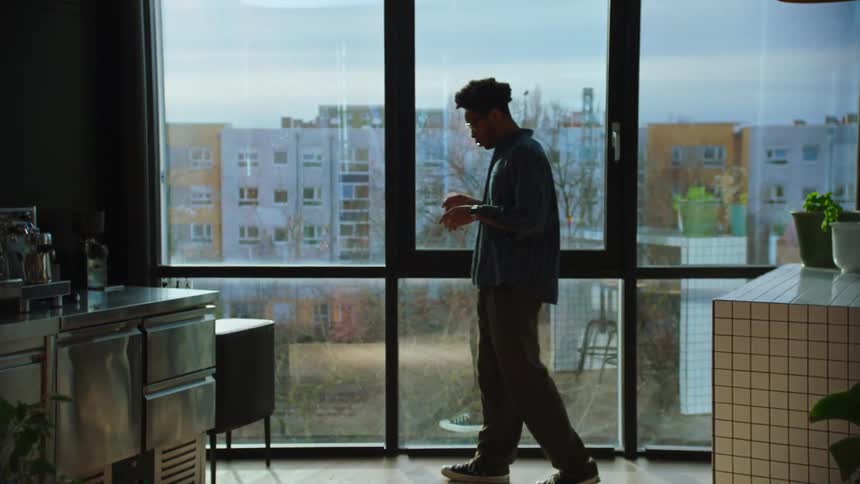 A clip of a male walking and contemplating in a room
