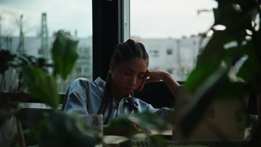 An employee almost falls asleep at her desk
