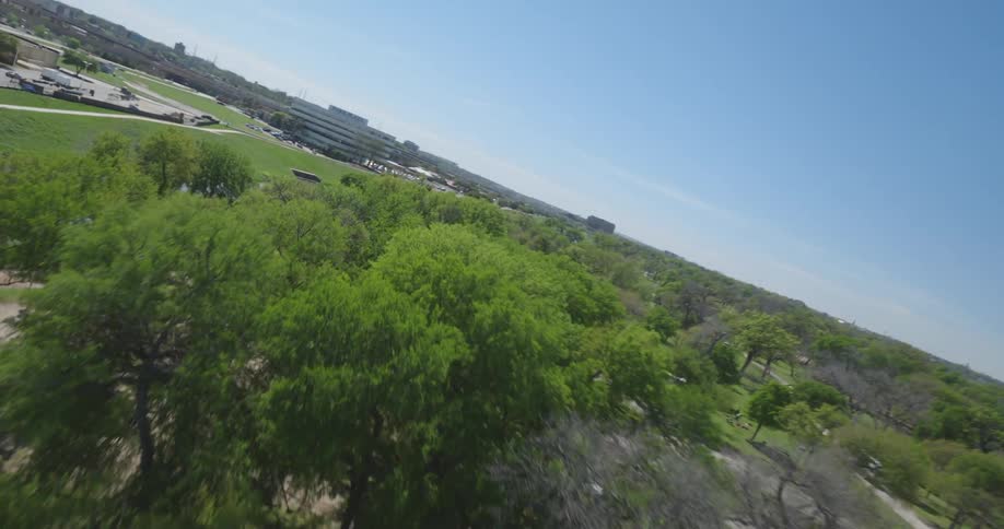 Aerial view of a railroad bridge and a river on a park under a blue sky
