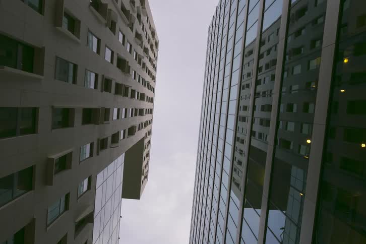 Upwards view of two skyscraper buildings at dusk
