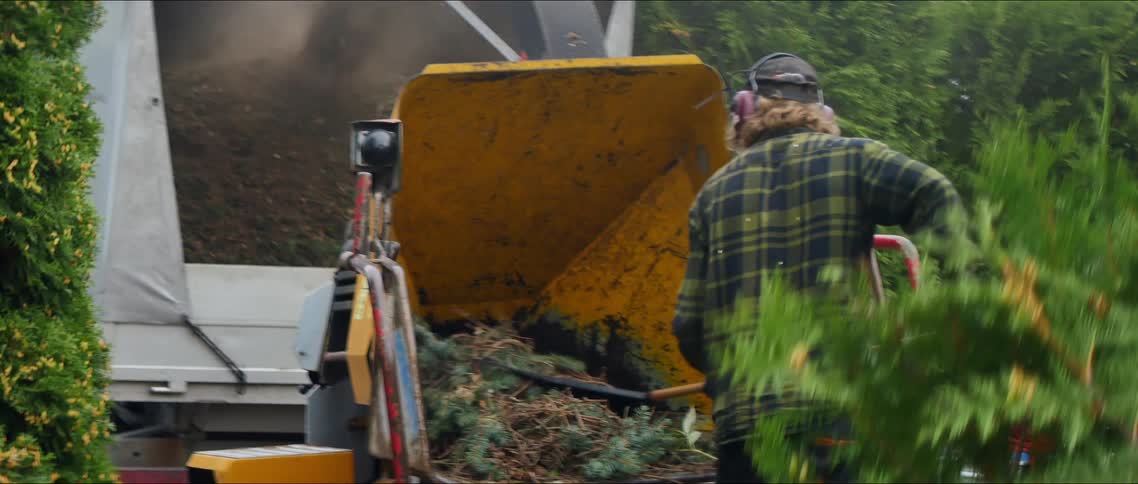 Landscaper shredding tree branches