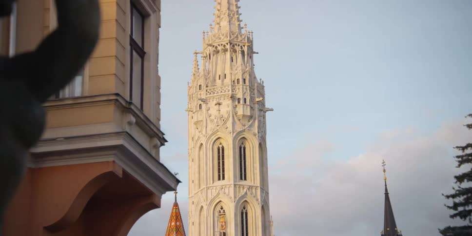 Bird flies through sky near Holy Trinity Square across from Matthias Church in oldtown Budapest