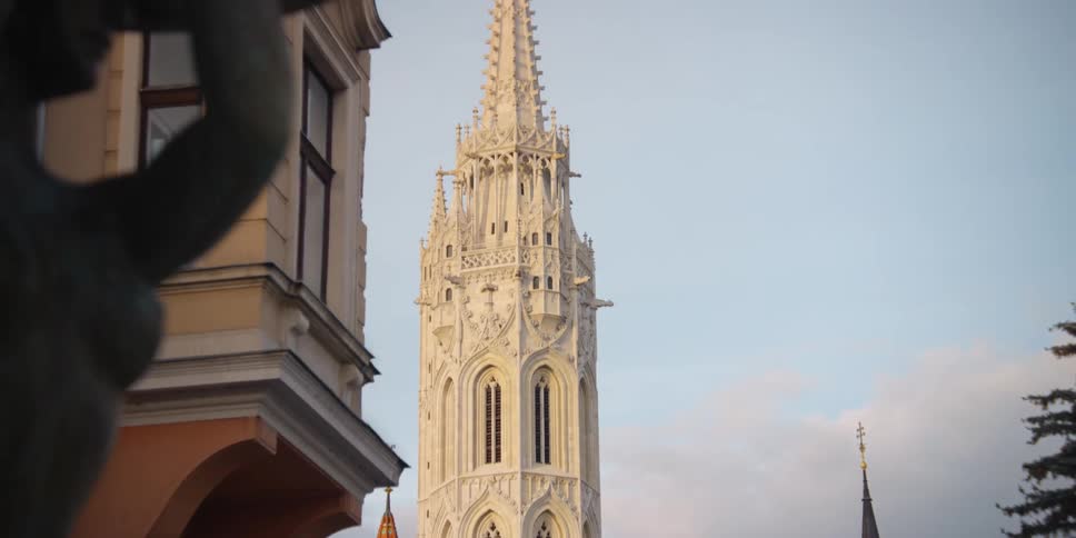 Pigeon lands on fountain in Holy Trinity Square across from Matthias Church in oldtown Budapest
