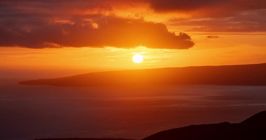 A time lapse of a coastal area shows the sun setting overhead