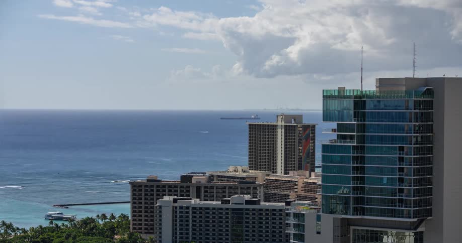 Landscape of a hotel area on the edge of a bluer sky on a day with clouds and in timelapse