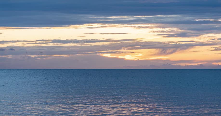 Time lapse of a sunrise over a calm sea