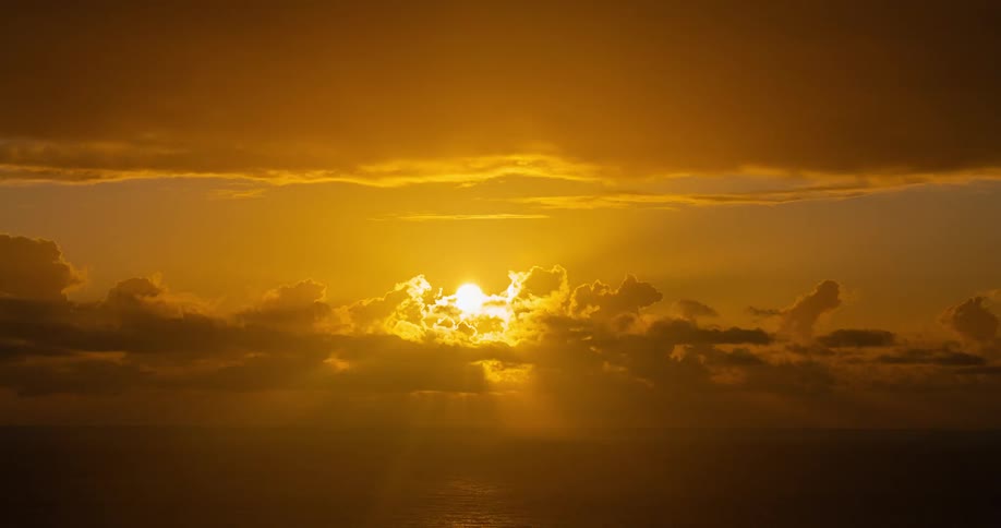 Landscape of the sun rising in time lapse above the sea