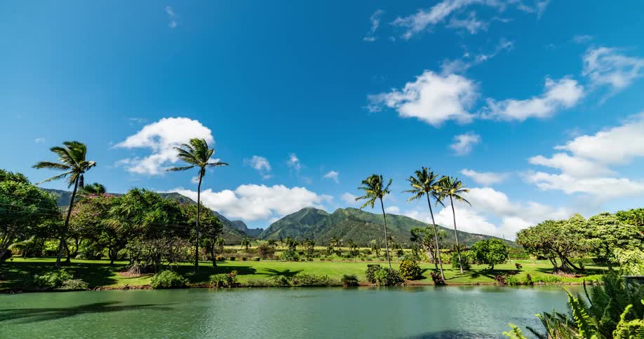 Time lapse of white clouds rolling across a tropical island on a windy day