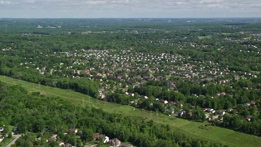 Aerial view of a small town in a rural area under a blue sky