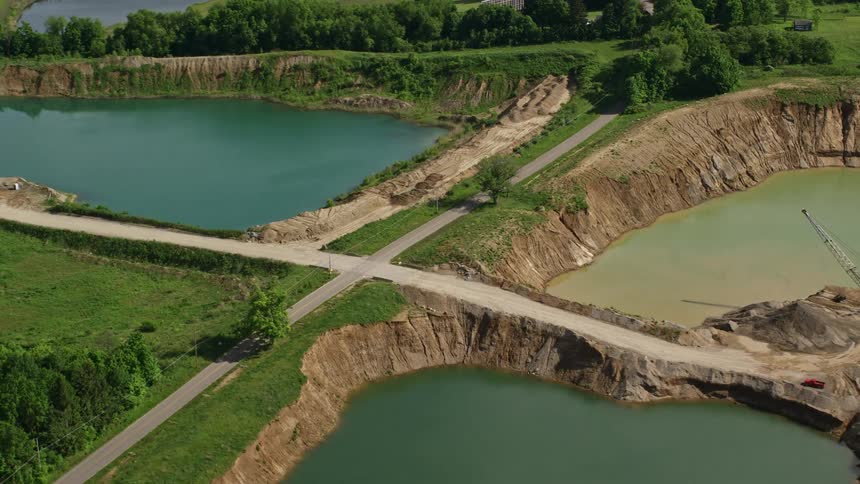 Aerial panorama of craters with water next to a highway