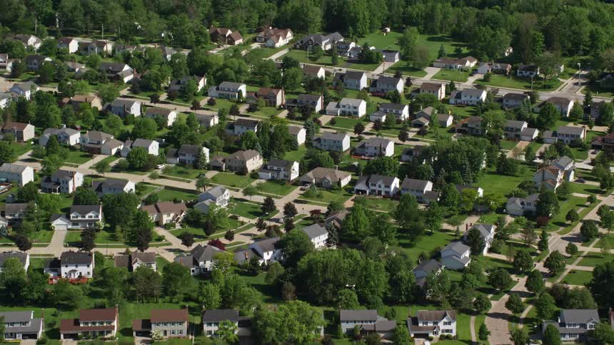 Aerial panorama of a residential neighborhood with houses and tree vegetation
