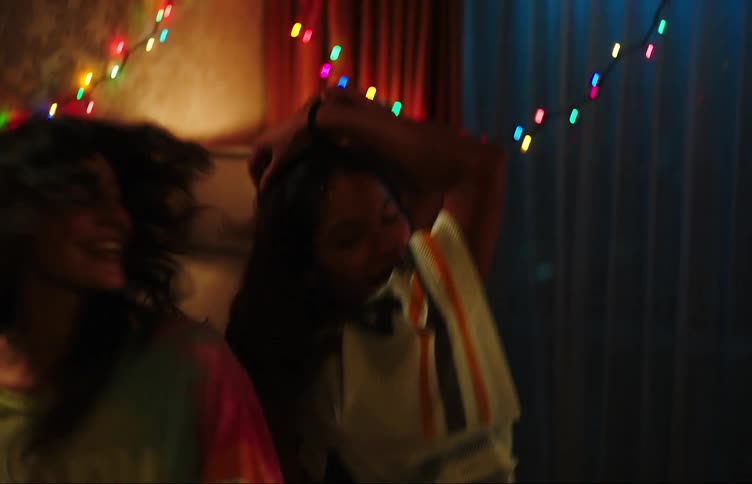 A couple of happy friends dancing on a party