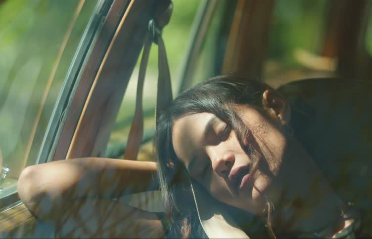 Portrait of a teenage girl sleeping in the passenger seat of a car