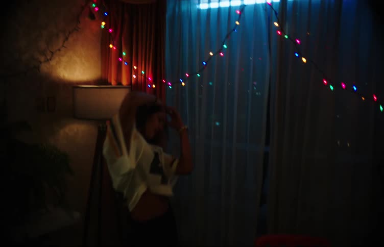 Two young teenage girls having fun while not dancing in the room indoors