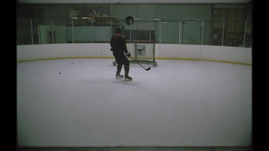 A hockey player shoots the puck