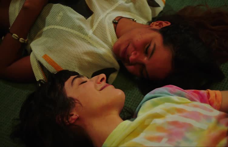Two teenage girls talking and laughing