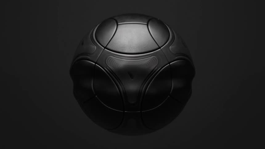 A black soccer ball that has ripples moving on its surface
