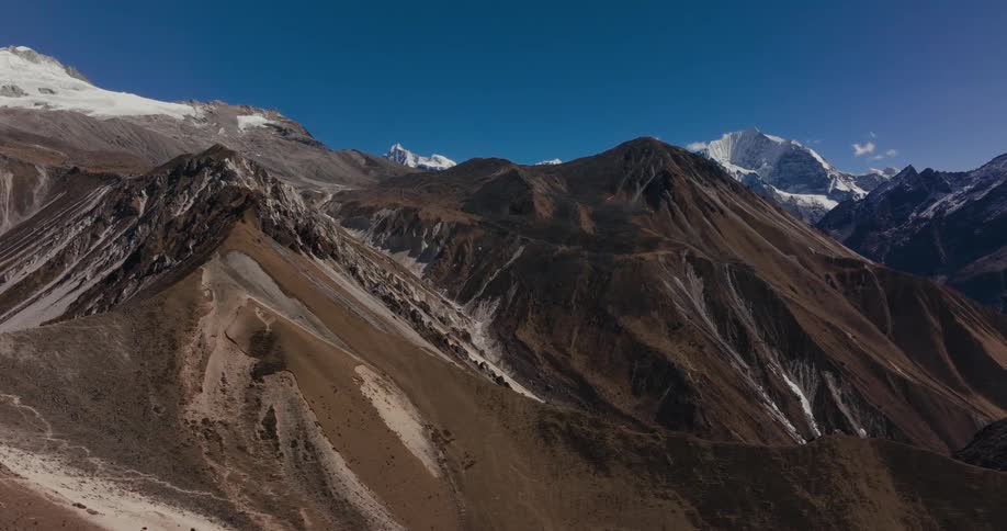 Aerial scenery of rocky mountains in blue sky winter