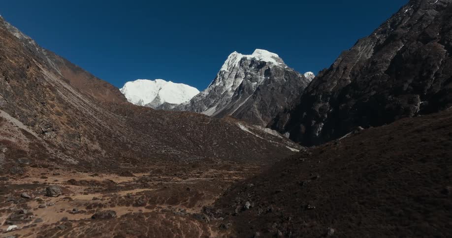 A stone covered valley between mountains