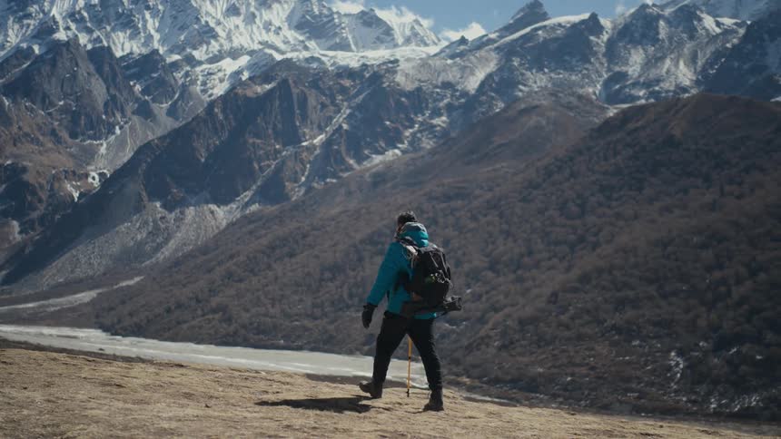 A hiker walking along a mountain range