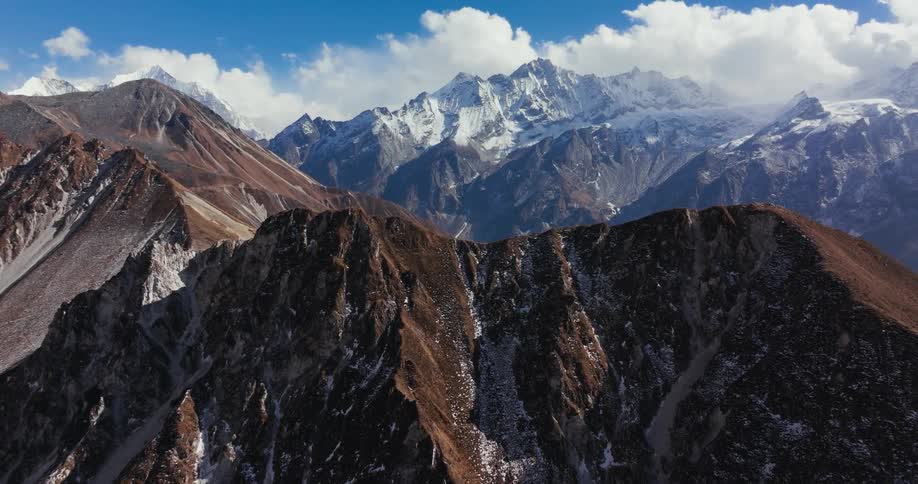 Aerial scenery of big mountains with snow during daytime