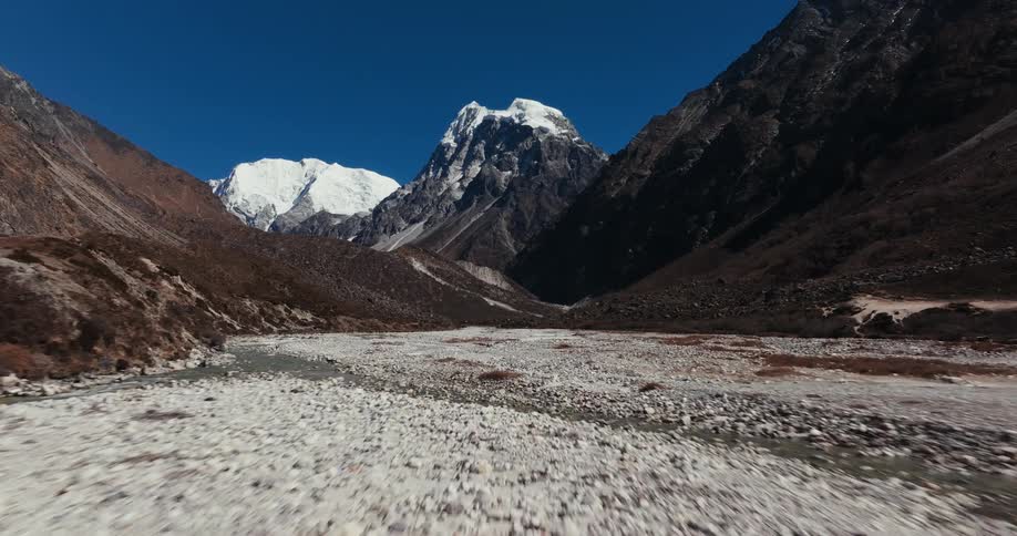 Rocky ground with mountains around on a blue sky day