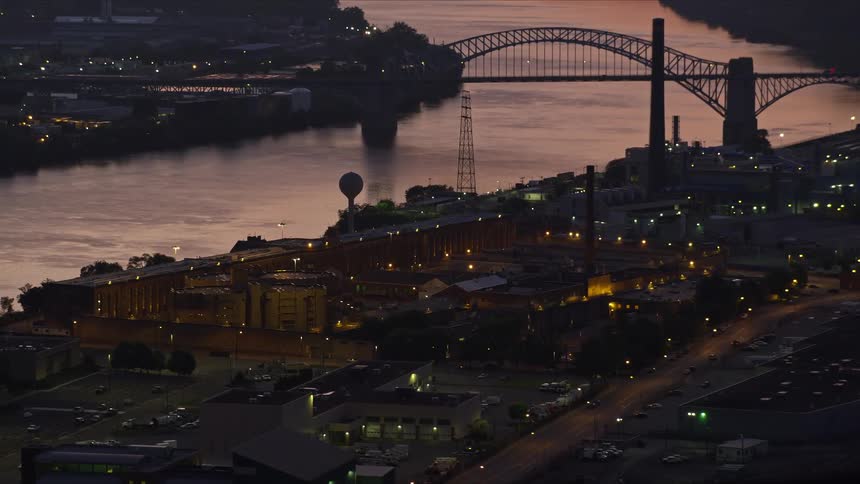 Aerial panorama of an urban city on the edge of a river with a bridge in a sunrise