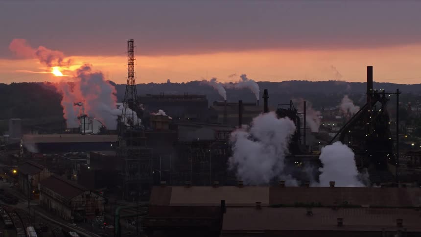 Smoke comes out of the large factory