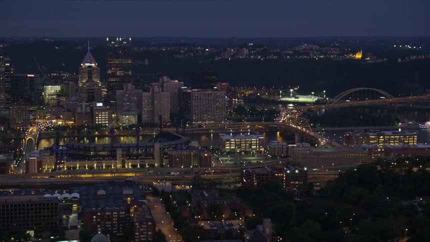 Cars drive through the city at night